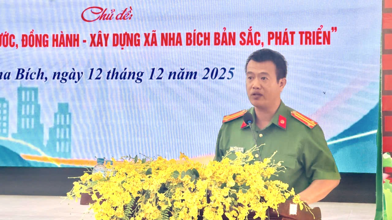 A person in uniform standing in front of a sign