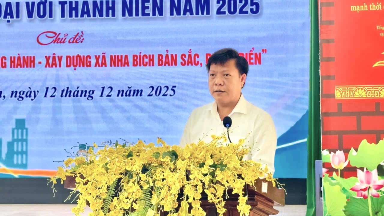 '''A person standing at a podium with a microphone

AI-generated content may be incorrect.'''